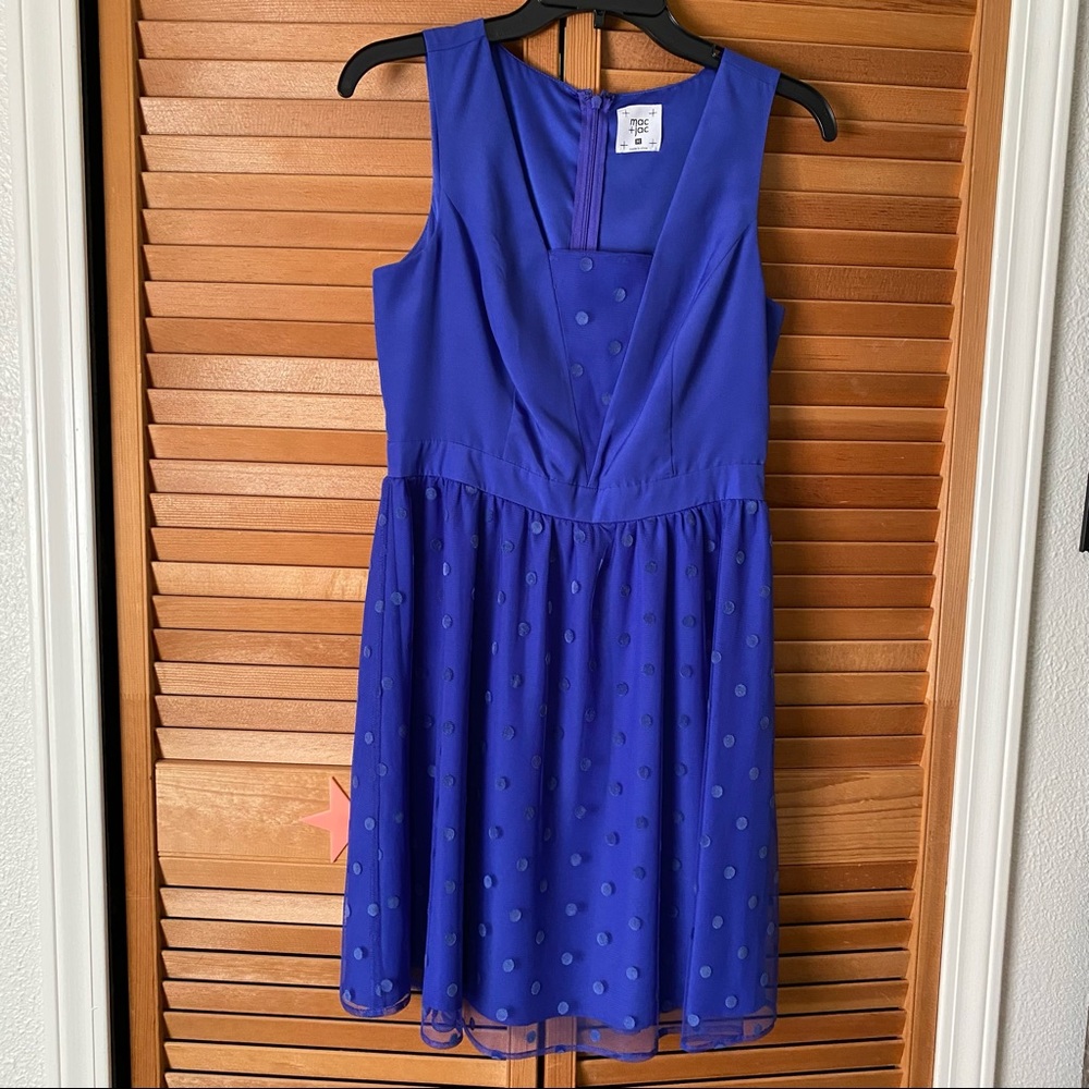 Blue dressy sleeveless dress with polka dot overlay and inner lining on bottom.
